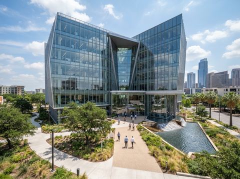 Modern glass office building representing a cloud-based cybersecurity company's headquarters.