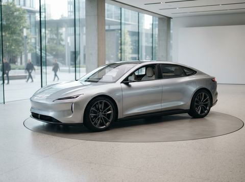A sleek unbranded electric vehicle prototype displayed under bright studio lighting.
