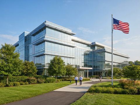 Exterior of a modern pharmaceutical research campus building under bright daylight.