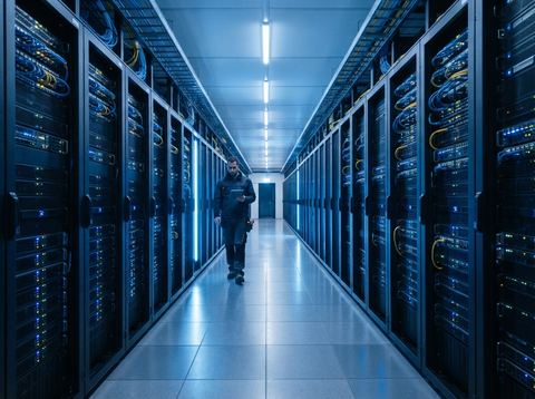 Modern data center corridor with illuminated server racks representing enterprise software infrastructure.