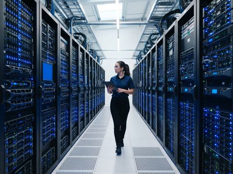 Server racks with glowing status lights in a modern data center corridor